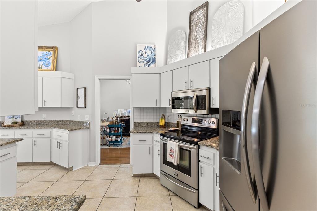 3734 Thornbush Lane New Port Richey, FL 34655 - Photo 9 of 47 a kitchen with stainless steel appliances a stove microwave and a refrigerator