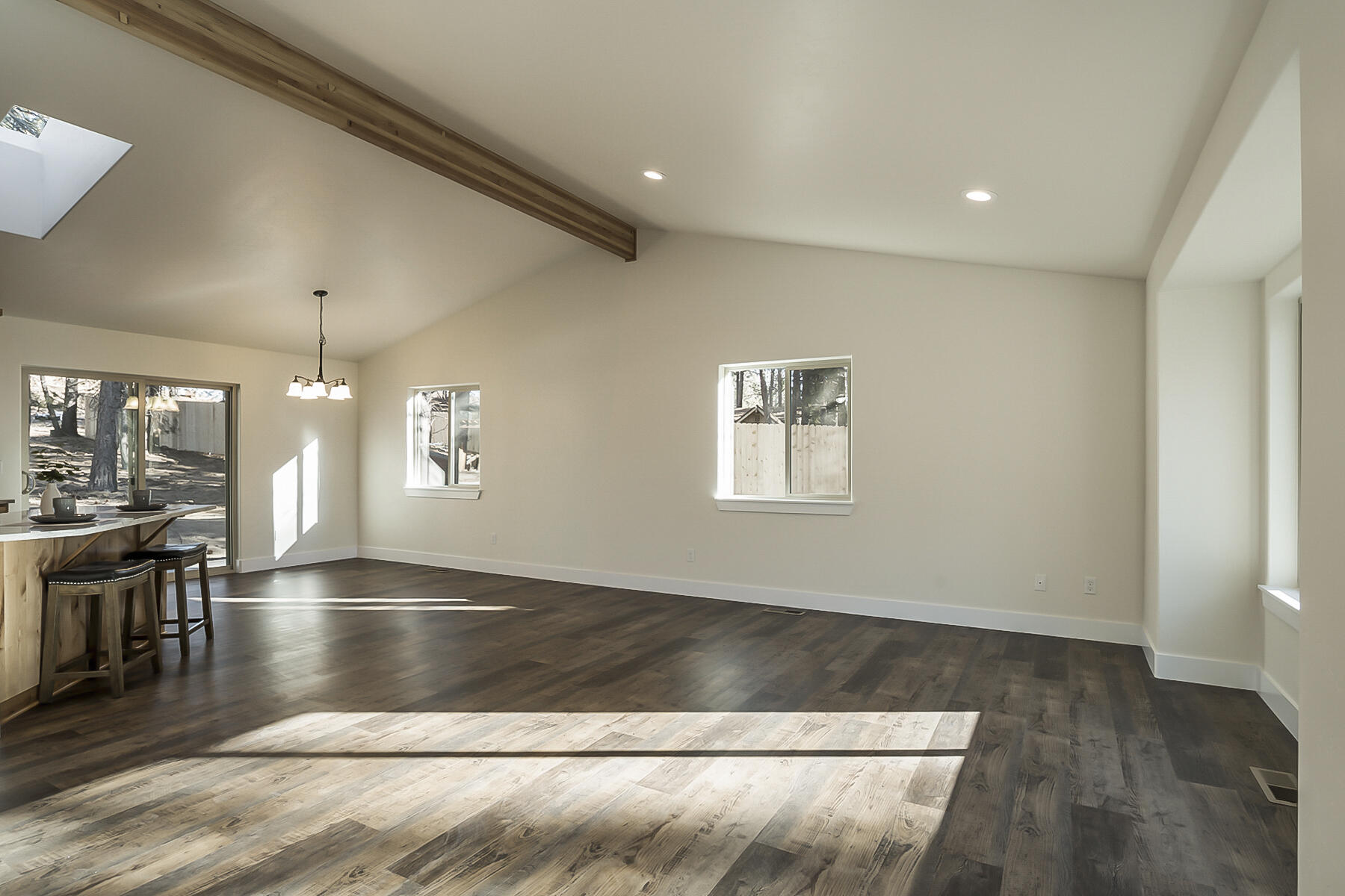 19220 Cherokee Road Bend, OR 97702 - Photo 11 of 25 an empty room with wooden floor and windows