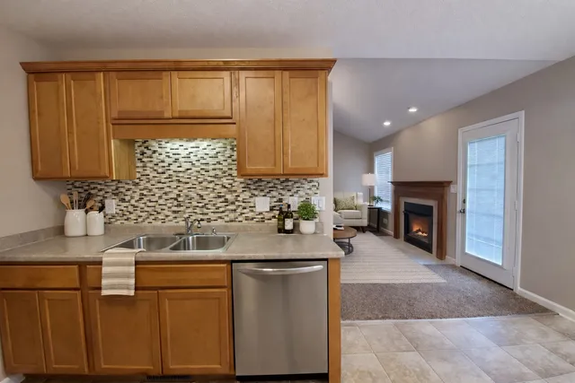 a kitchen with stainless steel appliances granite countertop a sink stove and cabinets
