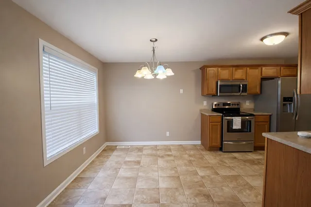 a view of a kitchen with a stove cabinets