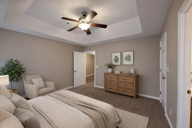 a bedroom with a bed and ceiling fan