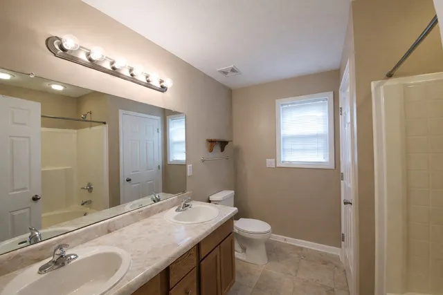 a bathroom with a double vanity sink and a mirror