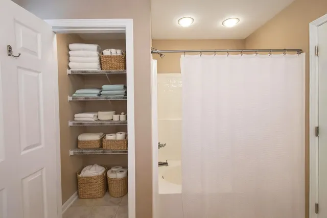 a view of walk in closet with empty racks