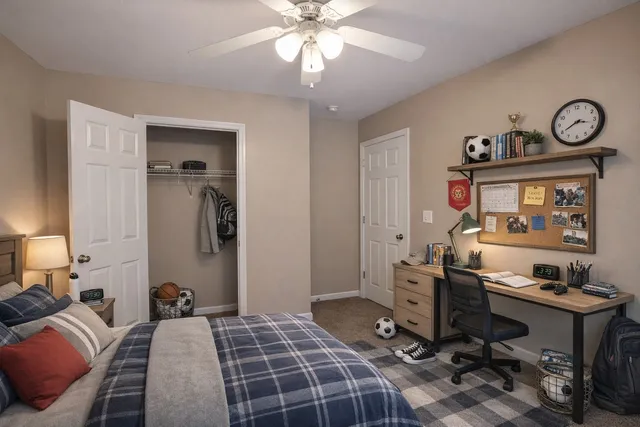 a bedroom with a bed and a chandelier