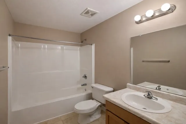 a bathroom with a sink toilet a shower and a mirror