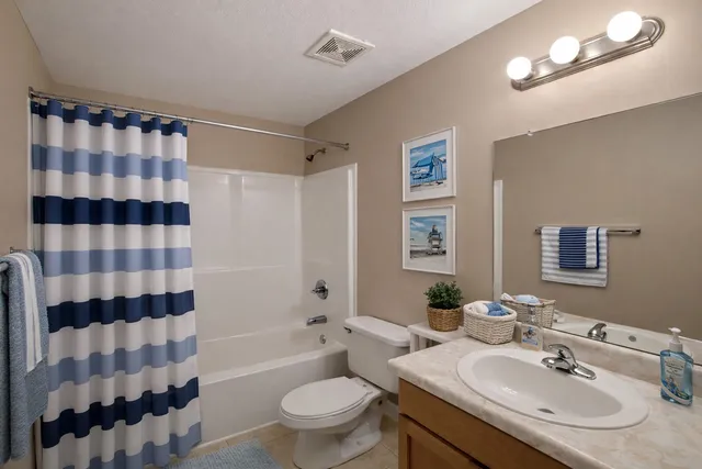 a bathroom with a sink toilet a shower a mirror and a bathtub