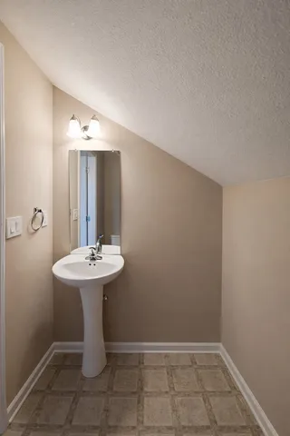a bathroom with a sink a toilet and mirror