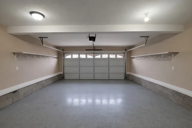 an empty room with windows and ceiling fan