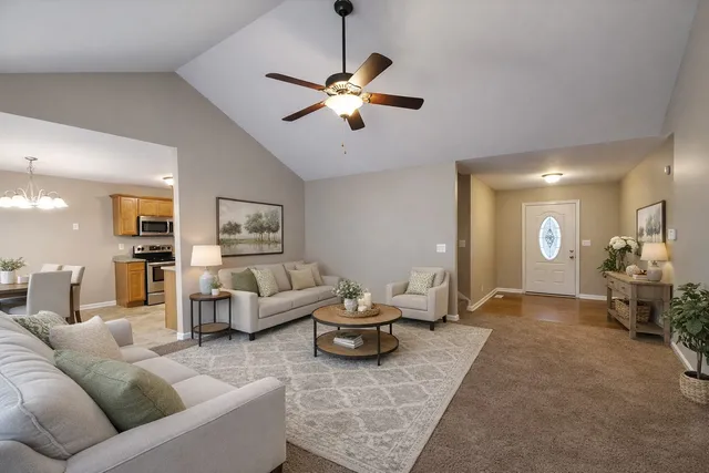 a living room with furniture and a chandelier