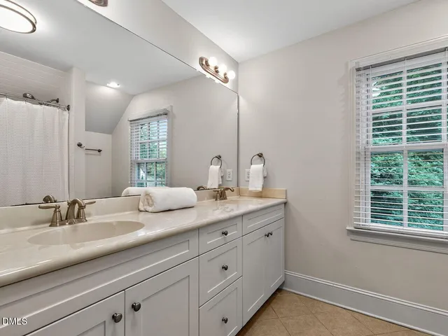 a bathroom with double sink and a mirror