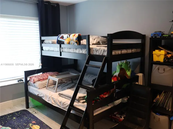 a living room with furniture a chandelier and a flat screen tv