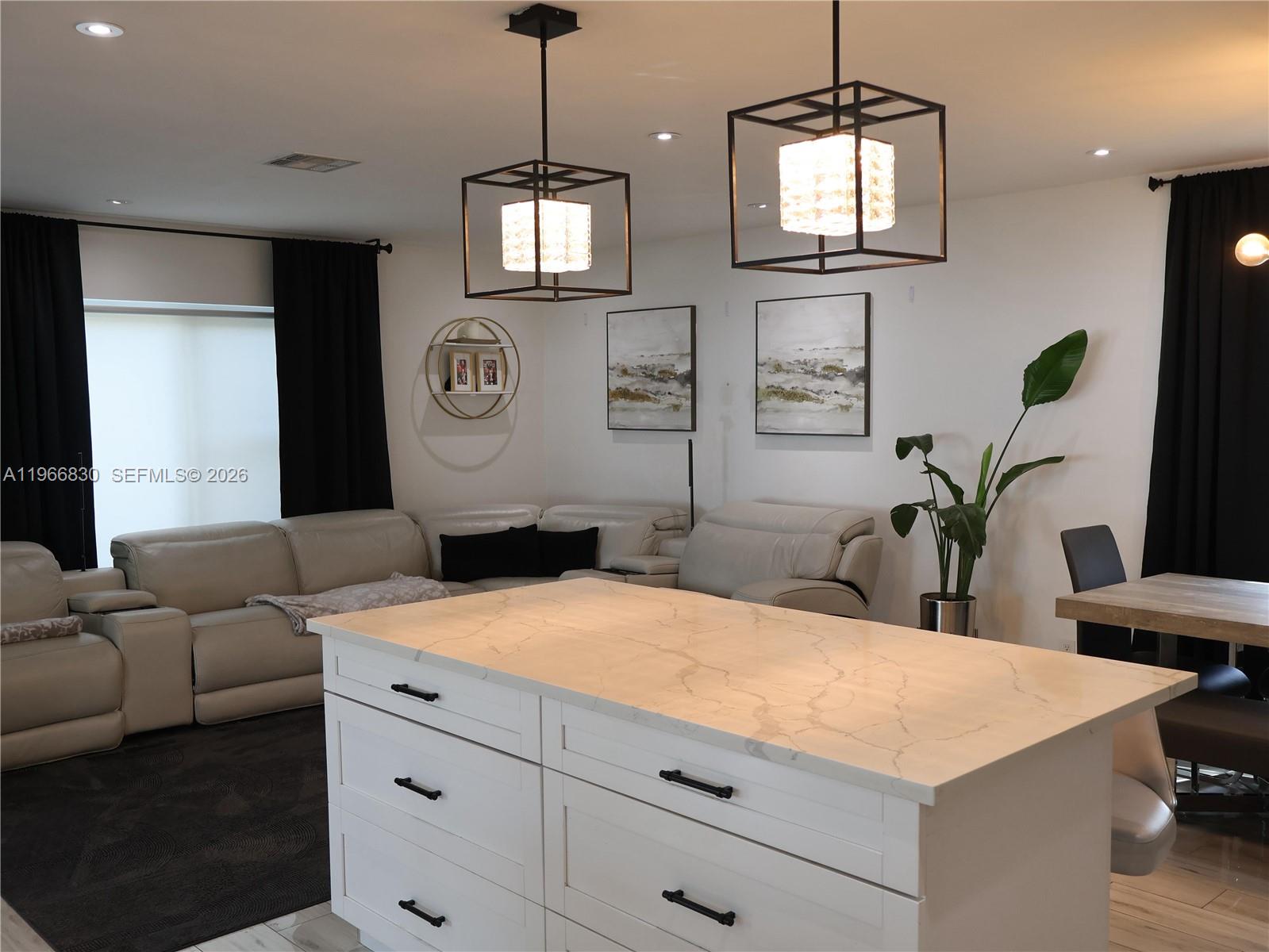 5505 Southwest 9th Street Margate, FL 33068 - Photo 13 of 53 a living room with furniture a chandelier and a flat screen tv