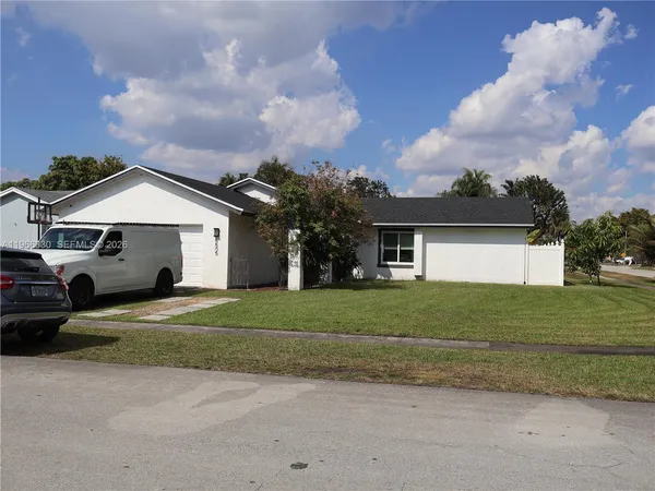 a view of a house with backyard porch and sitting area