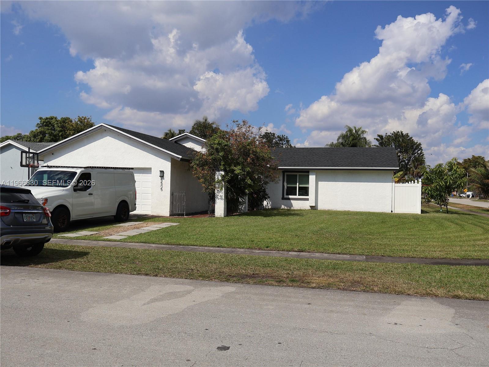 5505 Southwest 9th Street Margate, FL 33068 - Photo 17 of 53 a front view of a house with a yard and garage