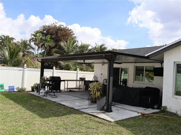 a kitchen with a table chairs refrigerator and microwave