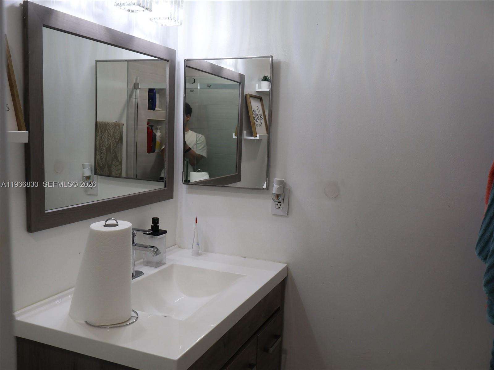 5505 Southwest 9th Street Margate, FL 33068 - Photo 25 of 53 a bathroom with a sink and a mirror