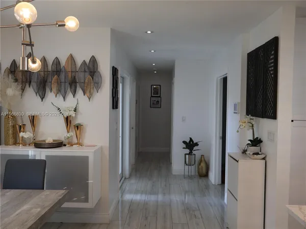 a kitchen with a table chairs refrigerator and microwave