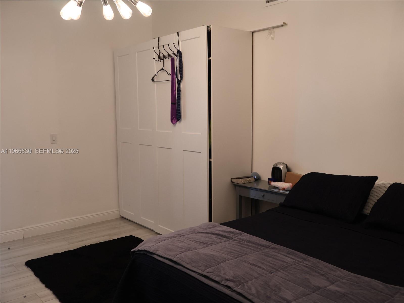 5505 Southwest 9th Street Margate, FL 33068 - Photo 35 of 53 a bedroom with a bed and a chair