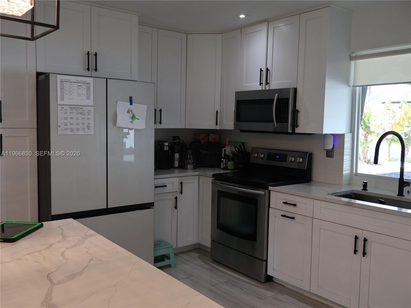 5505 Southwest 9th Street Margate, FL 33068 - Photo 36 of 53 a kitchen with stainless steel appliances granite countertop a refrigerator sink and microwave