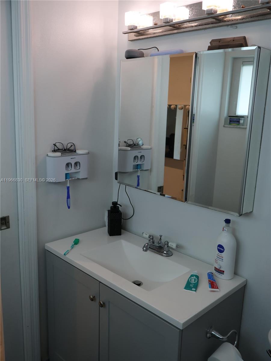 5505 Southwest 9th Street Margate, FL 33068 - Photo 37 of 53 a bathroom with a sink and a mirror