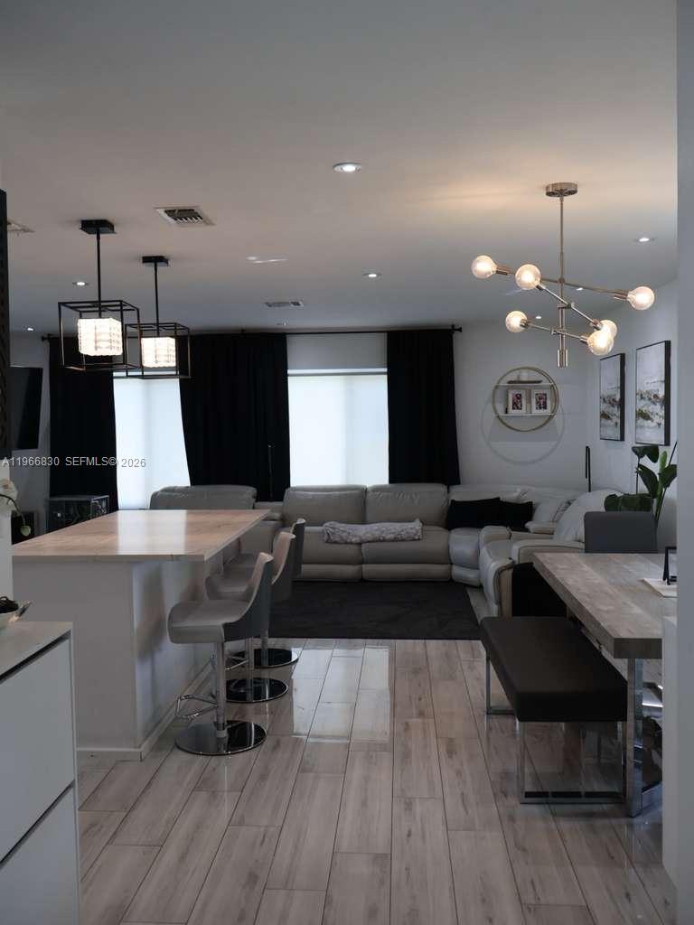5505 Southwest 9th Street Margate, FL 33068 - Photo 38 of 53 a living room with stainless steel appliances kitchen island granite countertop furniture a rug and a wooden floor