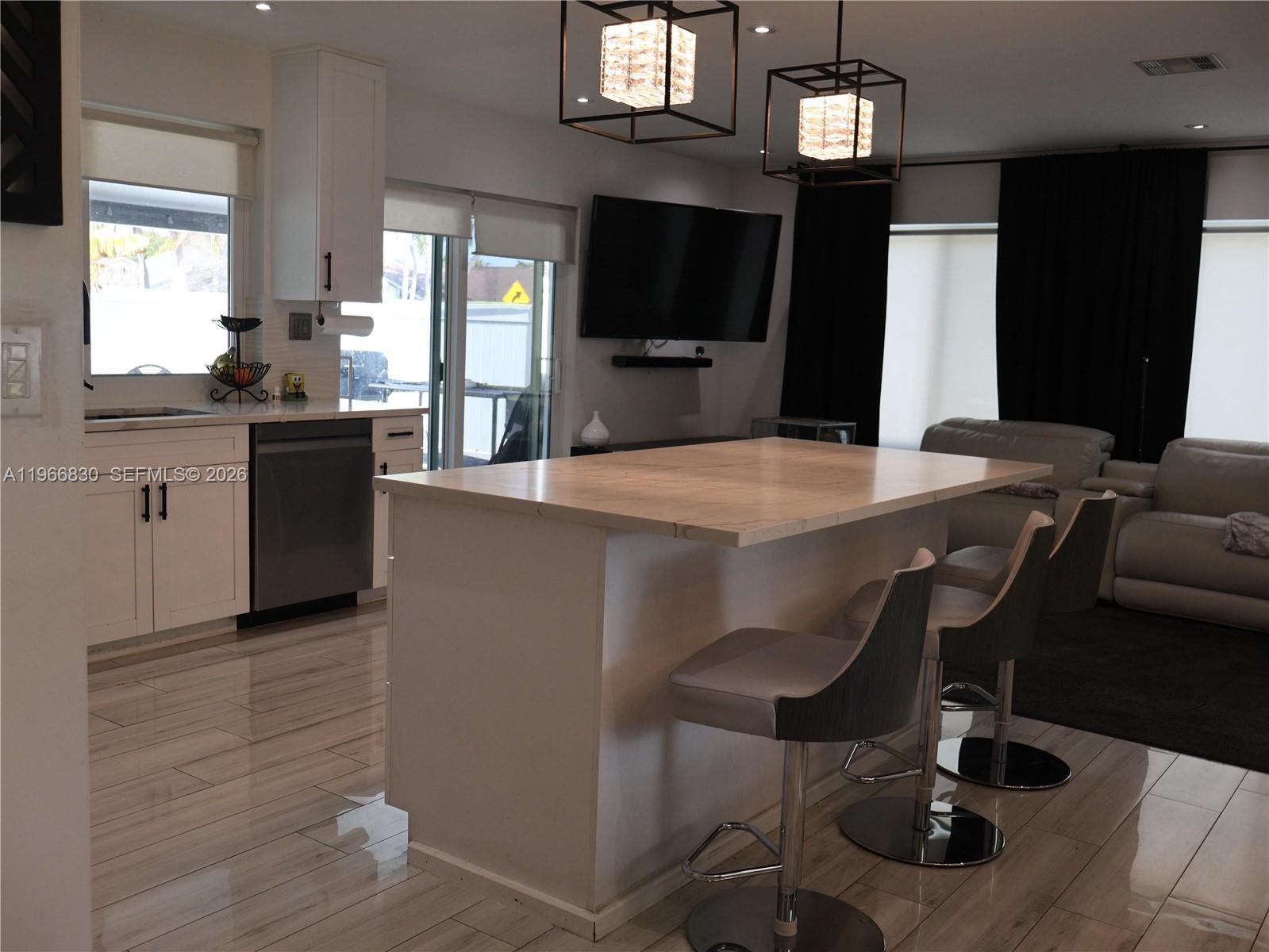 5505 Southwest 9th Street Margate, FL 33068 - Photo 4 of 53 a kitchen with a table chairs refrigerator and microwave