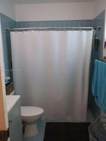 a view of a bathroom from a hallway