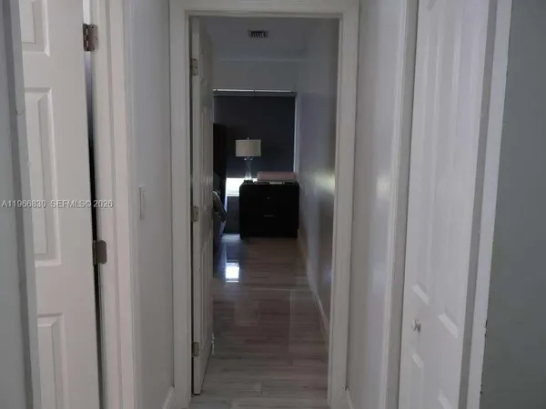 a living room with a bed furniture and painting on the wall