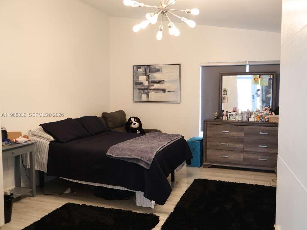 5505 Southwest 9th Street Margate, FL 33068 - Photo 44 of 53 a living room with a bed furniture and painting on the wall