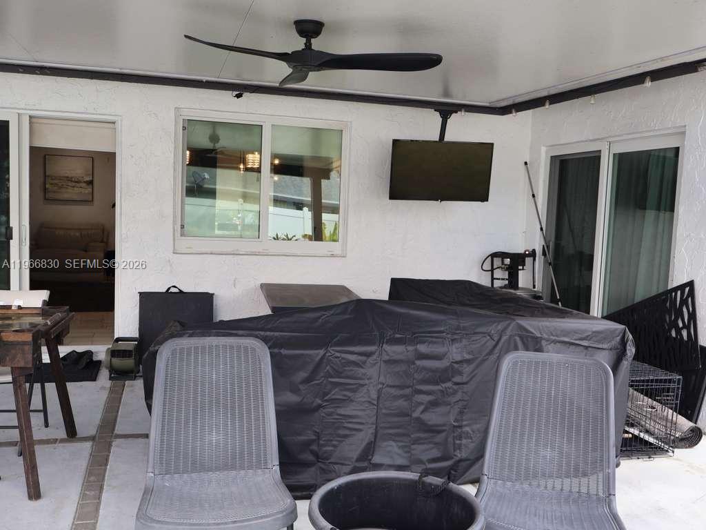 5505 Southwest 9th Street Margate, FL 33068 - Photo 53 of 53 a living room with furniture a flat screen tv and a window