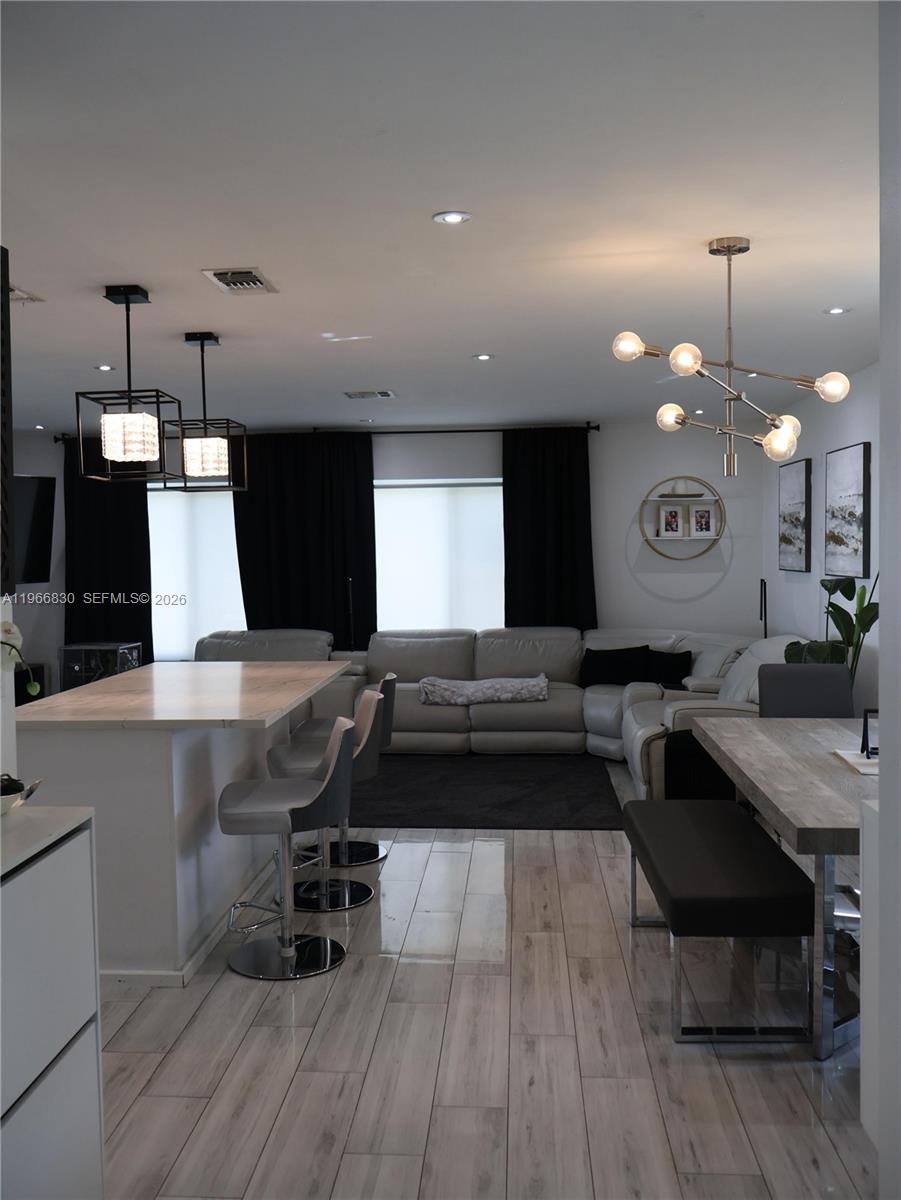 5505 Southwest 9th Street Margate, FL 33068 - Photo 7 of 53 a living room with stainless steel appliances kitchen island granite countertop furniture a rug and a wooden floor
