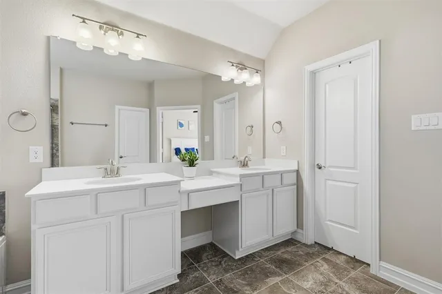 a bathroom with a tub a sink and glass door