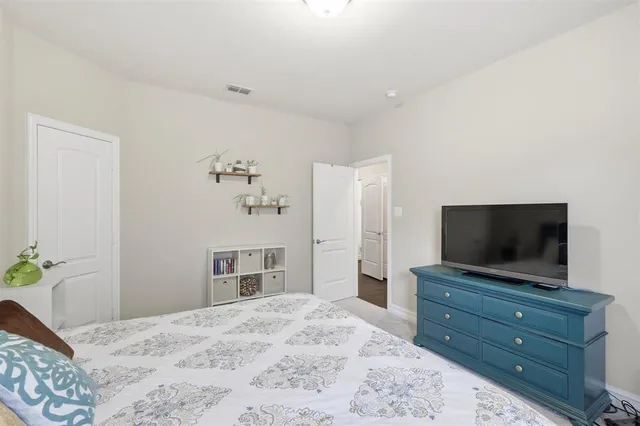 a bathroom with a double vanity sink toilet mirror and shower