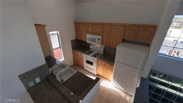 a view of kitchen with a sink and a stove top oven