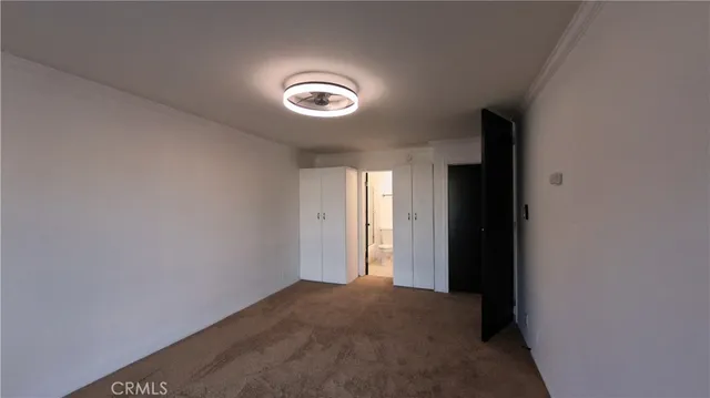 an empty room with windows and entrance