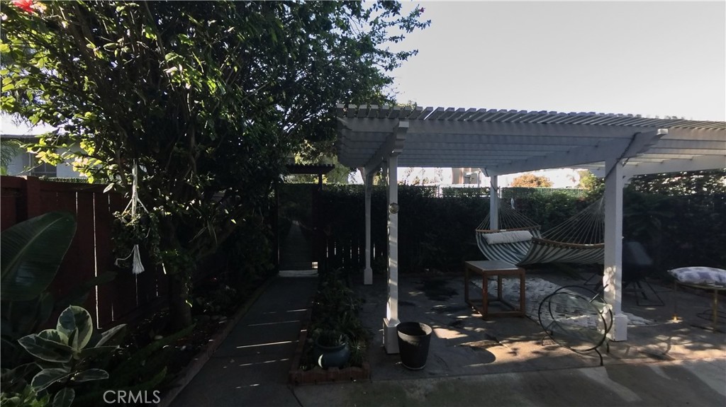 124 Buccaneer Street, Unit 1 Marina del Rey, CA 90292 - Photo 32 of 41 a patio with table and chairs and potted plants