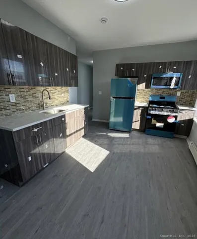 a kitchen with lots of counter top space and appliances