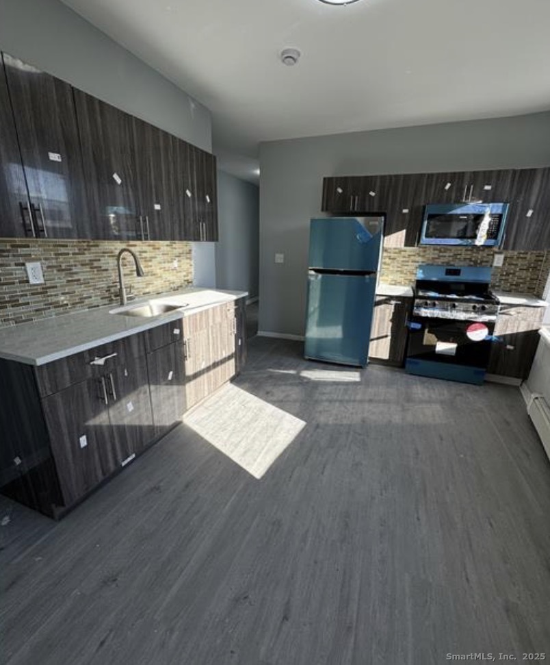a kitchen with lots of counter top space and appliances