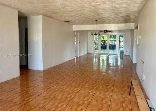 a kitchen with a refrigerator a sink and cabinets