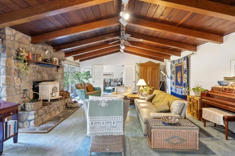 a living room with furniture a fireplace and a table