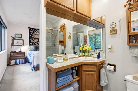 a bathroom with a sink vanity granite and a mirror