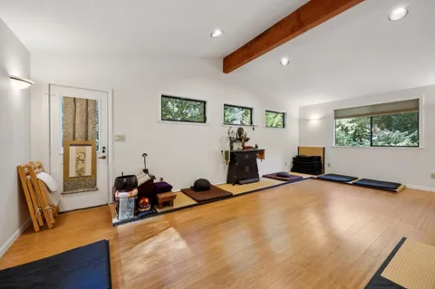 a view of a livingroom with workspace and a window