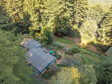 an aerial view of a house with a yard
