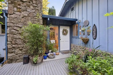 a view of a house with potted plants