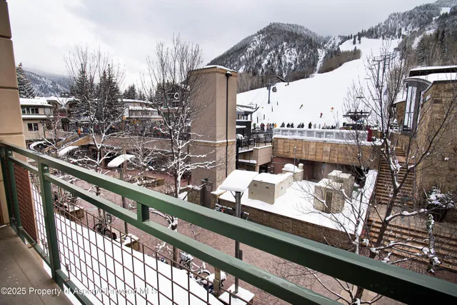 a view of a city from a balcony with furniture