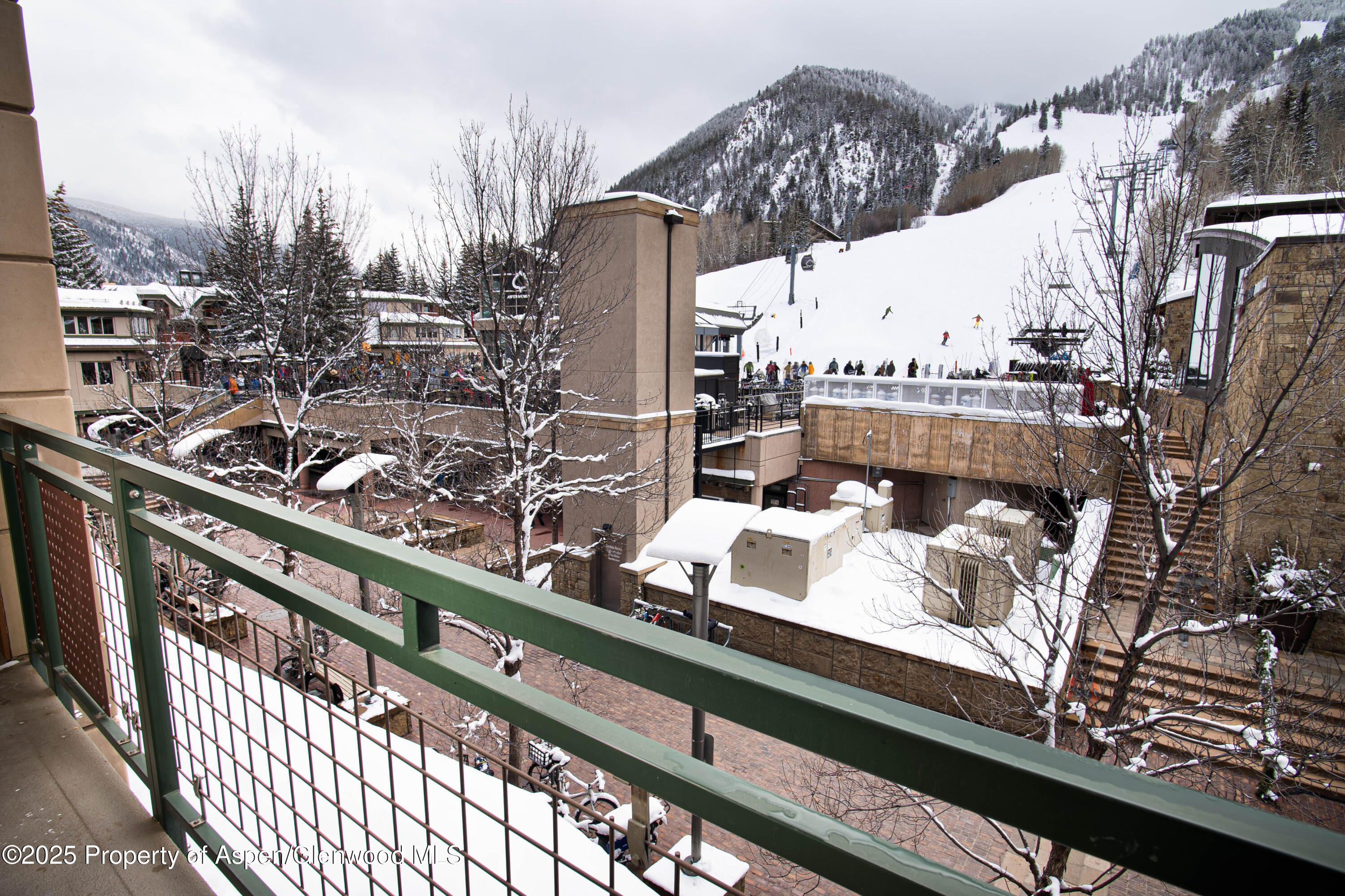 a view of a city from a balcony with furniture