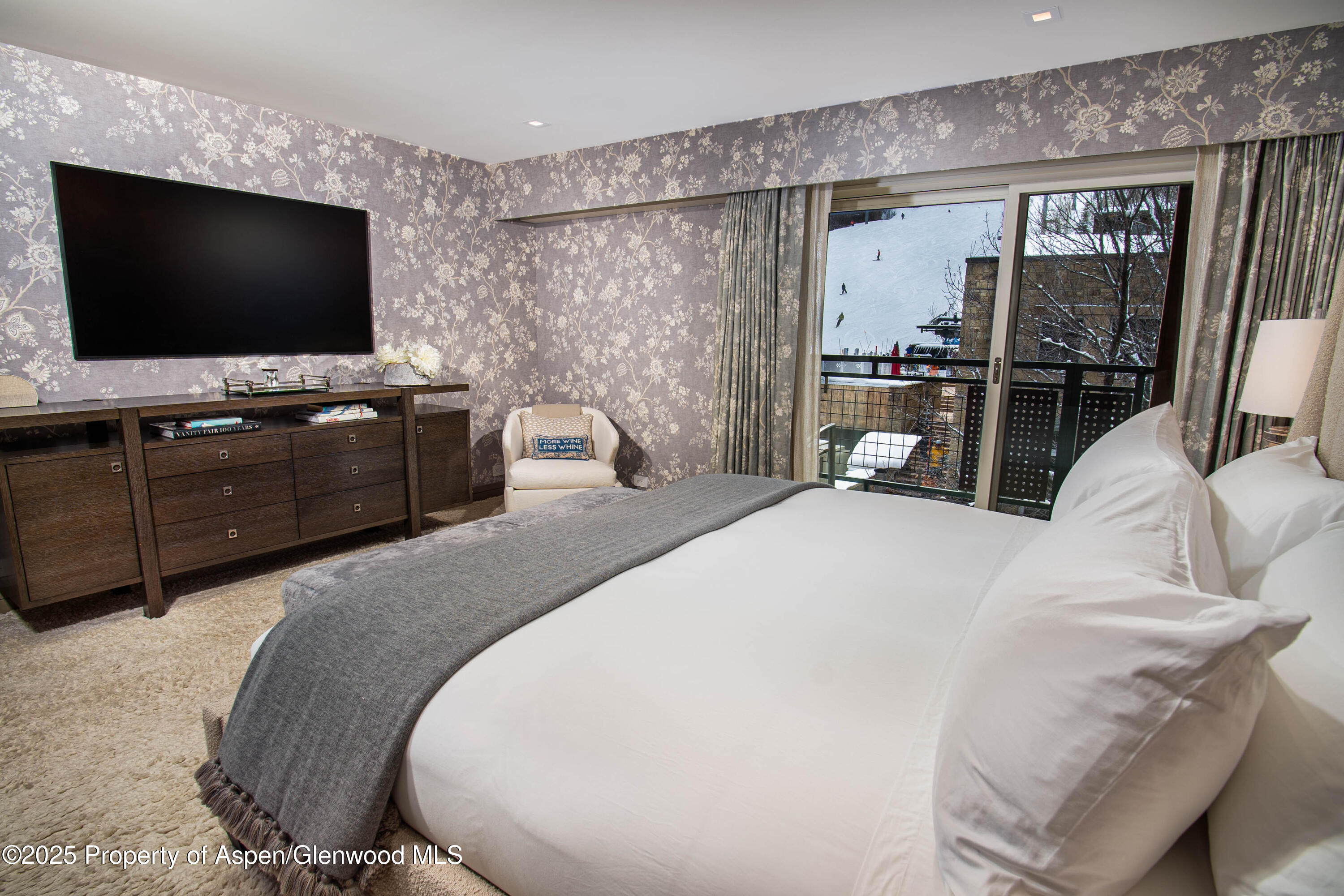 555 East Durant Avenue, Unit 3C Aspen, CO 81611 - Photo 11 of 16 a bedroom with a bed and a flat screen tv