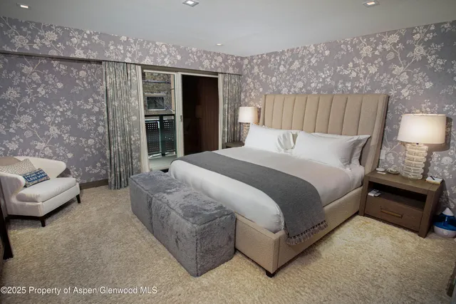 a spacious bedroom with a bed and a couch