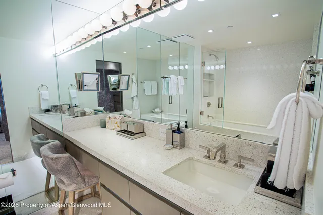 a bathroom with double vanity sinks and a mirror