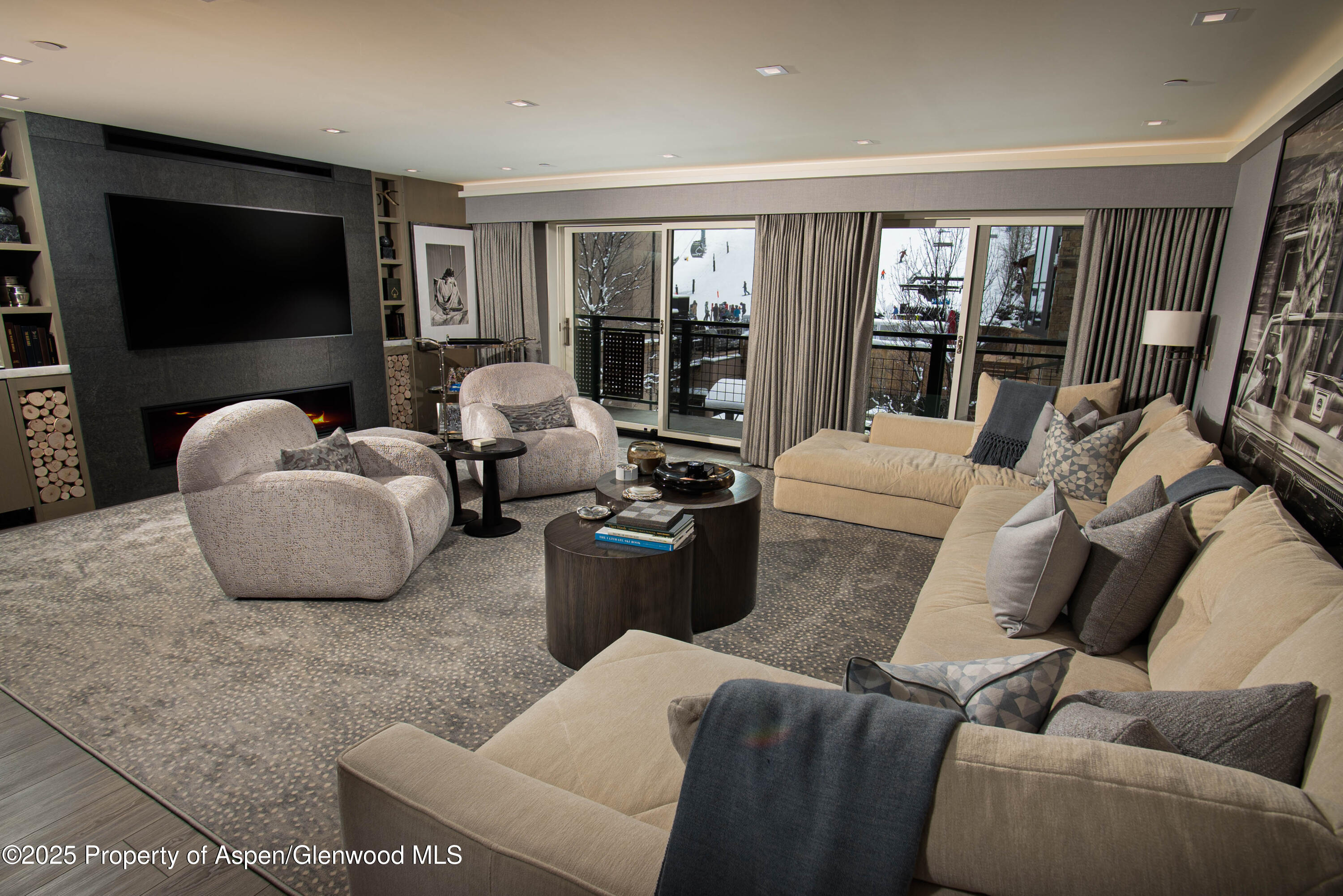 555 East Durant Avenue, Unit 3C Aspen, CO 81611 - Photo 2 of 16 a living room with furniture and a flat screen tv